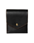 Black leather pouch with a gold button on a white background