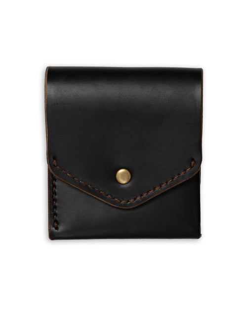 Black leather pouch with a gold button on a white background