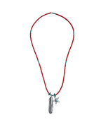 A beaded necklace featuring a red cord with small turquoise accents and a silver-toned pendant shaped like a feather with a small star charm.