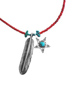 A red beaded necklace featuring a silver-toned feather pendant and a silver-toned five-pointed star pendant with a turquoise stone in the center, accented with small turquoise beads on the cord.